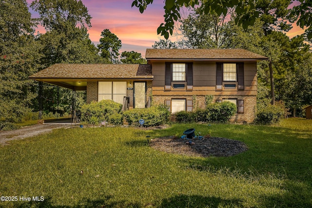 tri-level home with a yard and a carport