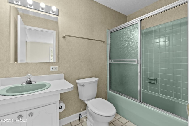 bathroom featuring toilet, shower / bath combination with glass door, tile patterned flooring, and vanity