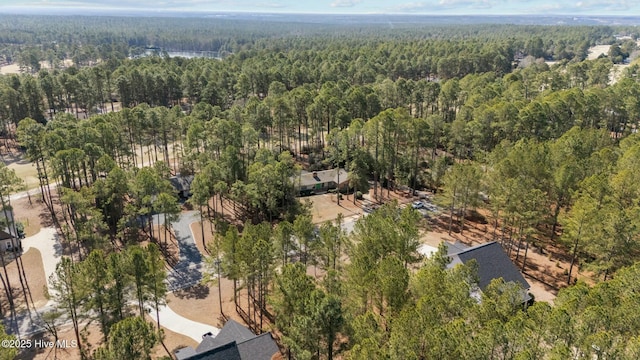 birds eye view of property featuring a view of trees