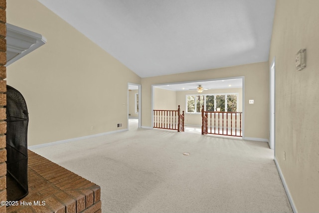 carpeted living room featuring lofted ceiling, visible vents, baseboards, and a ceiling fan