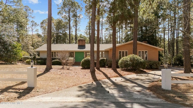 single story home with fence and a chimney