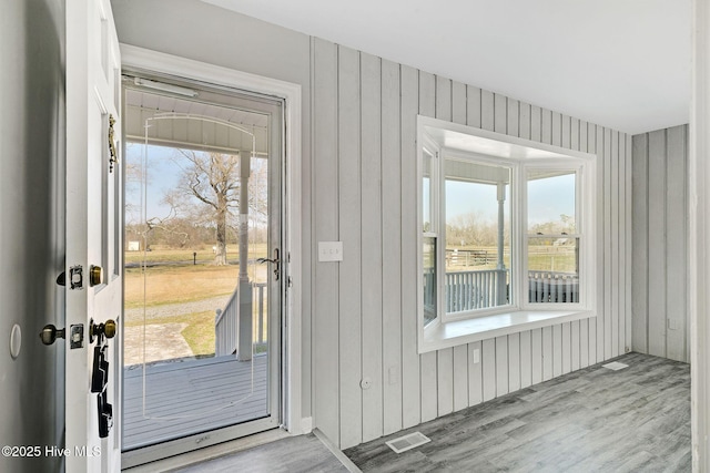entryway with visible vents, plenty of natural light, and wood finished floors