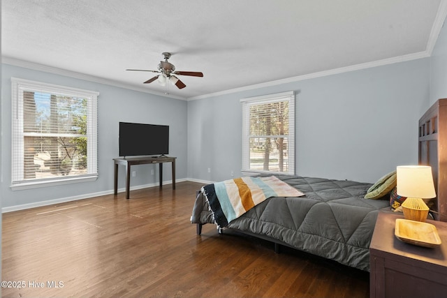 bedroom featuring crown molding, multiple windows, baseboards, and wood finished floors