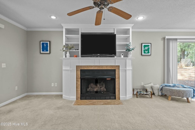 living area with ornamental molding, light colored carpet, a textured ceiling, and baseboards