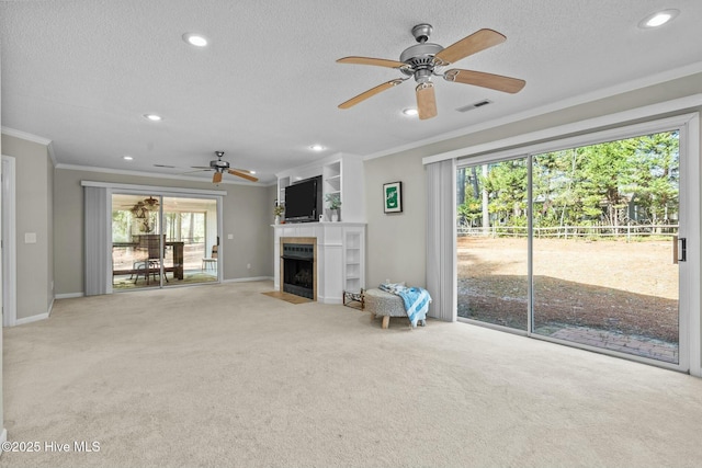 unfurnished living room featuring light carpet, visible vents, a textured ceiling, and ornamental molding