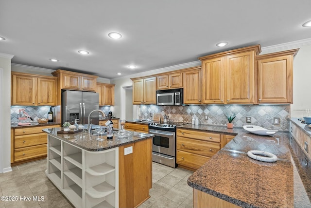 kitchen with light tile patterned floors, open shelves, appliances with stainless steel finishes, a kitchen island with sink, and a sink