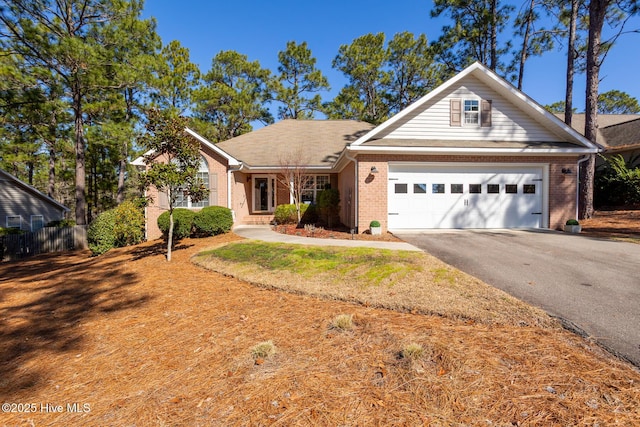 view of front facade featuring driveway, an attached garage, and brick siding