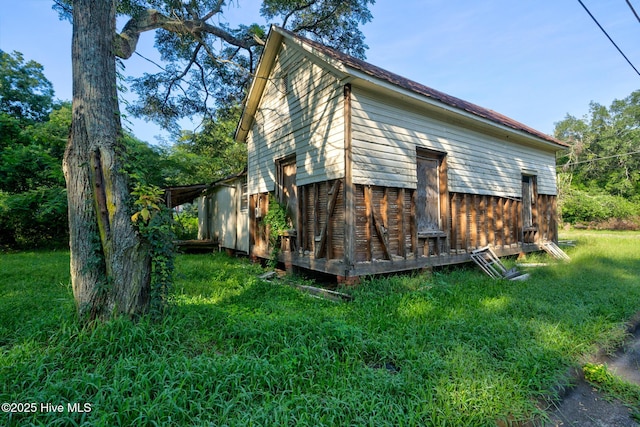 view of side of property with a yard