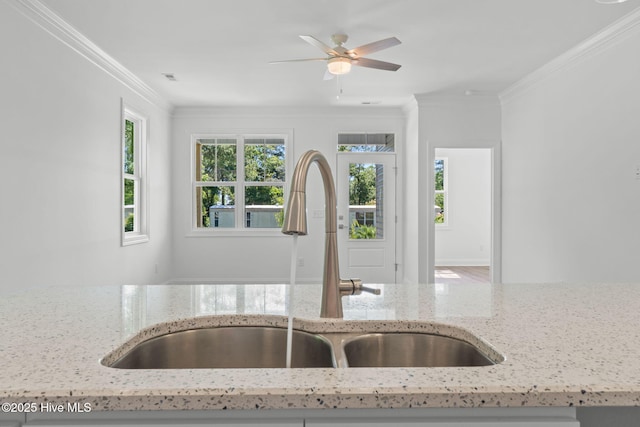 211 NE 78th St, Oak Island, NC 28465 - kitchen with a sink, light stone countertops, crown molding, and a ceiling fan
