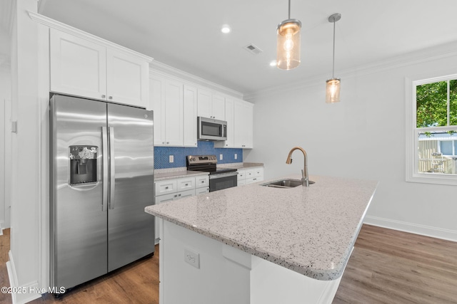 211 NE 78th St, Oak Island, NC 28465 - kitchen with appliances with stainless steel finishes, a sink, ornamental molding, white cabinets, and wood finished floors