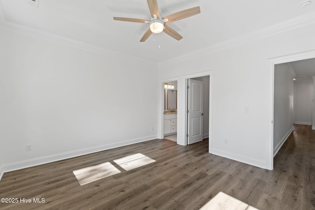 211 NE 78th St, Oak Island, NC 28465 - unfurnished bedroom featuring ornamental molding, wood finished floors, baseboards, and ensuite bath