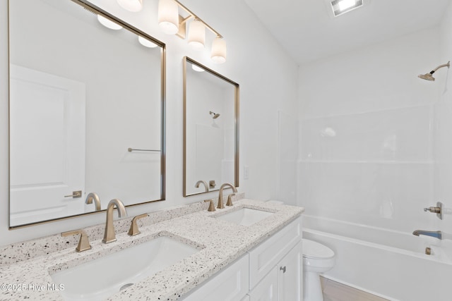 211 NE 78th St, Oak Island, NC 28465 - bathroom featuring double vanity, toilet, and bathtub / shower combination