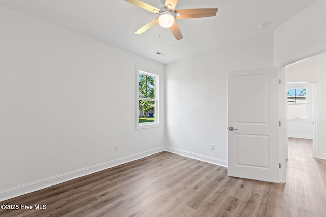 211 NE 78th St, Oak Island, NC 28465 - unfurnished room with wood finished floors, a ceiling fan, baseboards, and a smoke detector