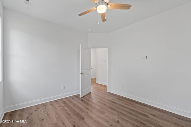 211 NE 78th St, Oak Island, NC 28465 - spare room featuring wood finished floors, ceiling fan, and baseboards