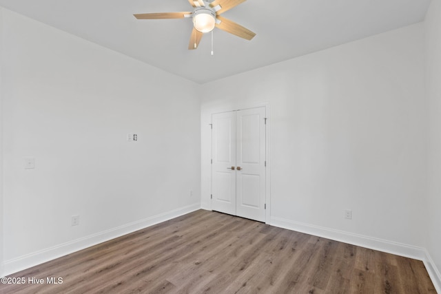 211 NE 78th St, Oak Island, NC 28465 - spare room with wood finished floors, baseboards, and a ceiling fan