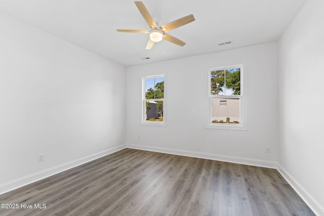 211 NE 78th St, Oak Island, NC 28465 - spare room featuring plenty of natural light, wood finished floors, ceiling fan, and baseboards