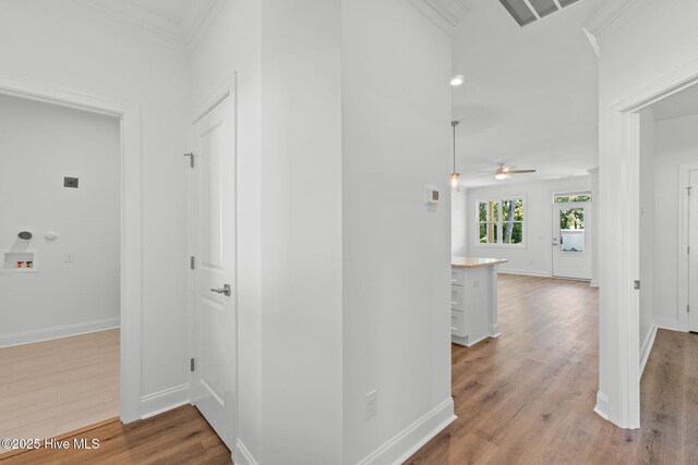 211 NE 78th St, Oak Island, NC 28465 - corridor featuring wood finished floors, baseboards, and ornamental molding
