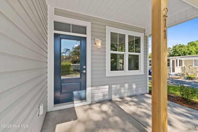 211 NE 78th St, Oak Island, NC 28465 - entrance to property with a porch