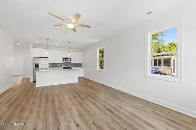211 NE 78th St, Oak Island, NC 28465 - unfurnished living room featuring recessed lighting, baseboards, crown molding, light wood-style floors, and a ceiling fan