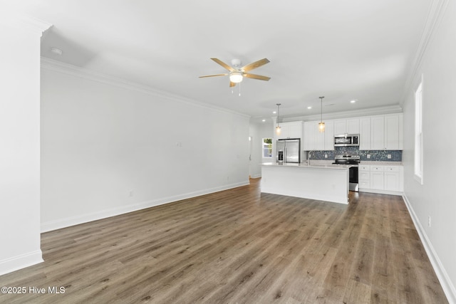 211 NE 78th St, Oak Island, NC 28465 - unfurnished living room with ceiling fan, wood finished floors, baseboards, recessed lighting, and crown molding