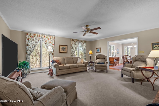 carpeted living room featuring ornamental molding, a textured ceiling, and ceiling fan with notable chandelier