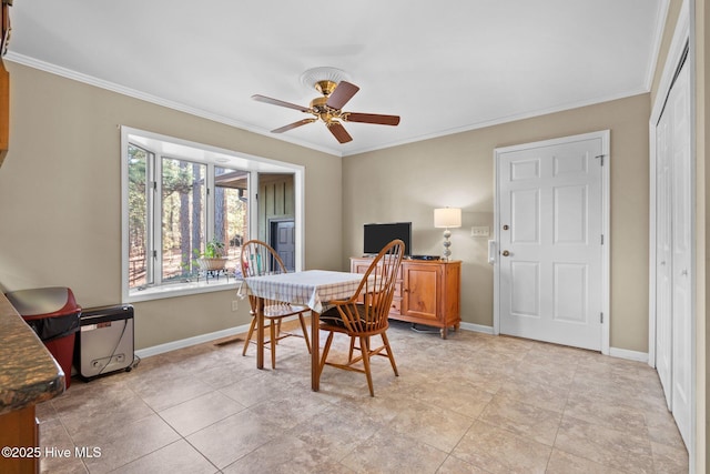 dining area featuring a ceiling fan, baseboards, and crown molding