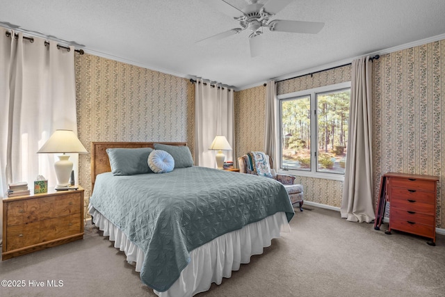 bedroom with a textured ceiling, carpet flooring, a ceiling fan, wallpapered walls, and crown molding