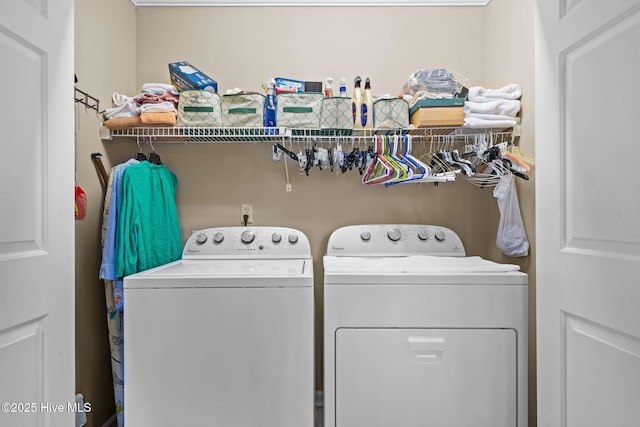 clothes washing area featuring laundry area and washing machine and clothes dryer