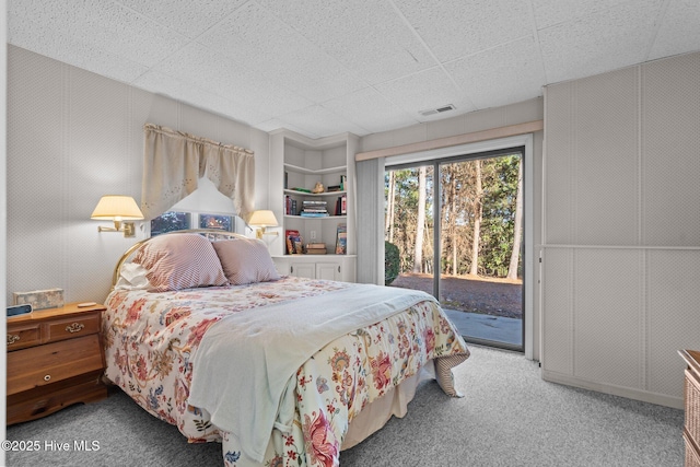 bedroom with carpet, access to outside, and visible vents