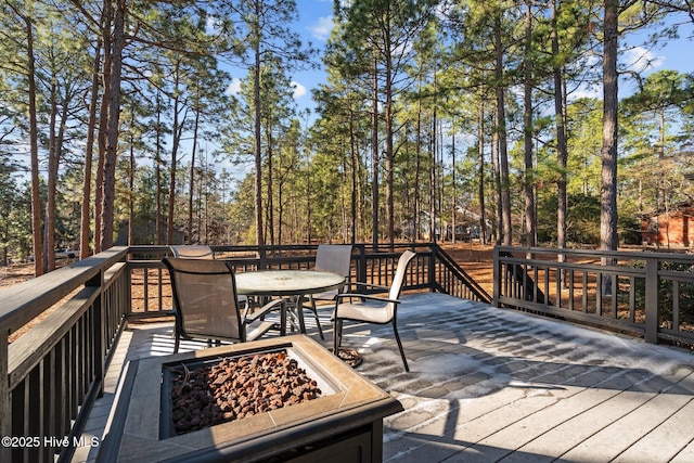 deck featuring a fire pit and outdoor dining space