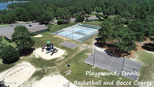 birds eye view of property featuring a water view and a view of trees