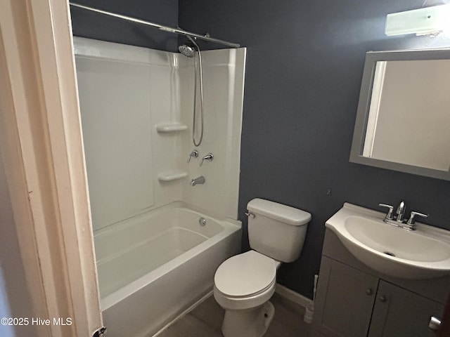 bathroom with shower / bathtub combination, vanity, toilet, and baseboards