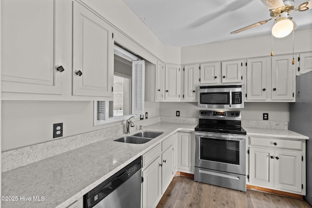 kitchen with sink, stainless steel appliances, dark hardwood / wood-style floors, and white cabinets