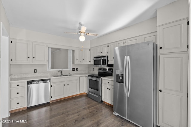 kitchen featuring sink, dark hardwood / wood-style floors, white cabinets, and stainless steel appliances