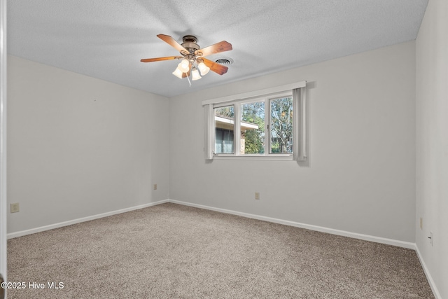 unfurnished room featuring ceiling fan, carpet, and a textured ceiling