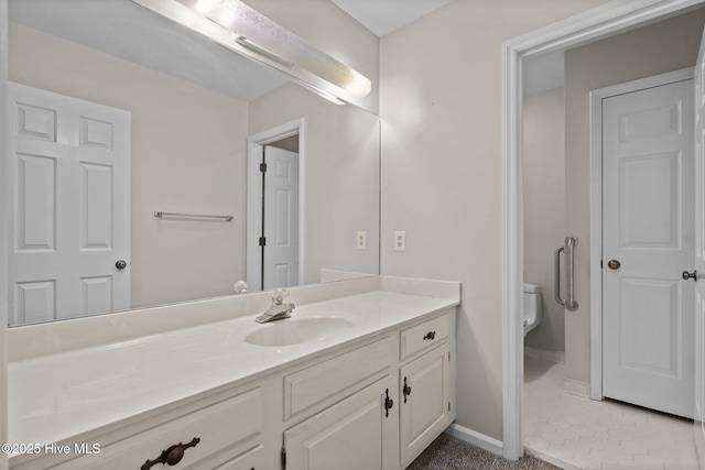 bathroom featuring tile patterned floors, toilet, and vanity