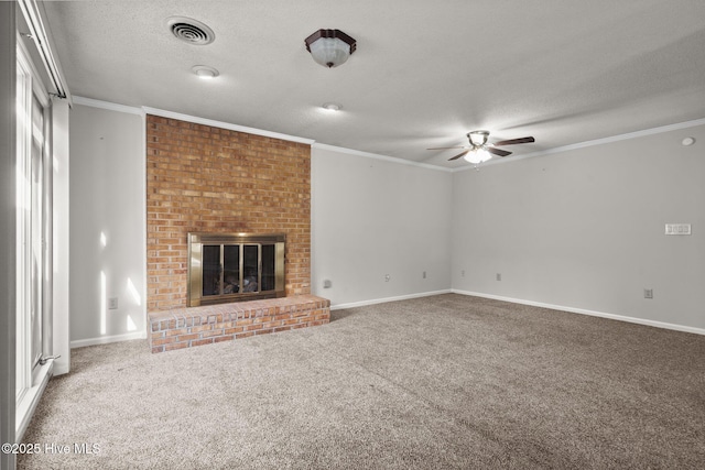 unfurnished living room featuring a fireplace, carpet flooring, crown molding, and a textured ceiling