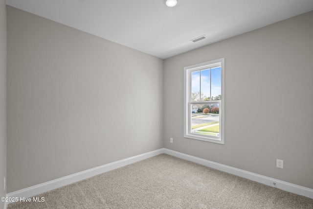 carpeted empty room with baseboards and visible vents