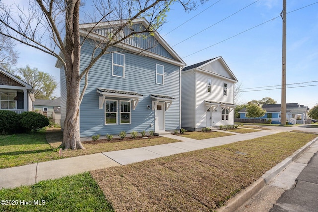 view of front of home with board and batten siding and a front yard