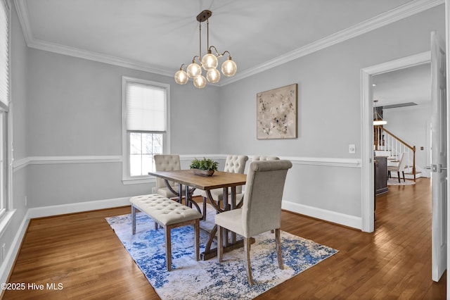 1307 Edgewater Club Rd, Wilmington, NC 28411 - dining area featuring stairway, a chandelier, ornamental molding, wood finished floors, and baseboards