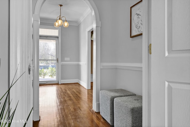 1307 Edgewater Club Rd, Wilmington, NC 28411 - foyer featuring dark wood-style flooring, arched walkways, crown molding, baseboards, and a chandelier