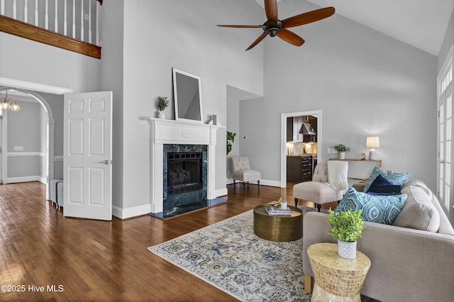 1307 Edgewater Club Rd, Wilmington, NC 28411 - living area with high vaulted ceiling, ceiling fan, a fireplace, wood finished floors, and arched walkways