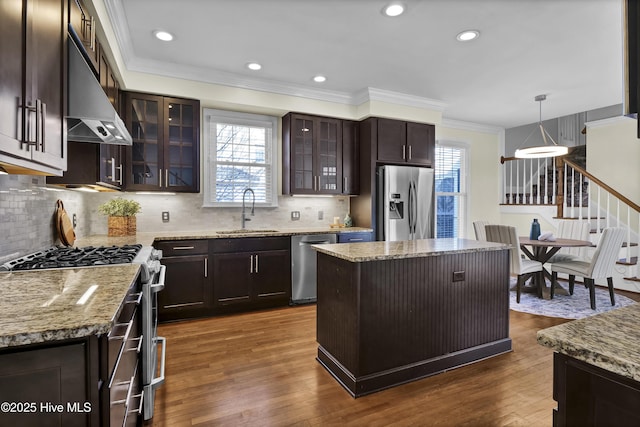 1307 Edgewater Club Rd, Wilmington, NC 28411 - kitchen with a sink, stainless steel appliances, ornamental molding, dark brown cabinets, and tasteful backsplash