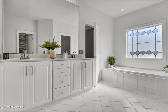 1307 Edgewater Club Rd, Wilmington, NC 28411 - bathroom featuring a garden tub, tile patterned flooring, and double vanity