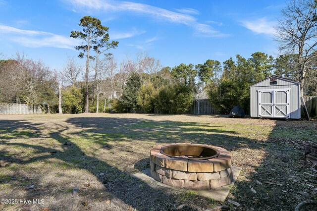 1307 Edgewater Club Rd, Wilmington, NC 28411 - view of yard featuring a fire pit, a shed, an outdoor structure, and view of wooded area