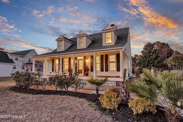 1307 Edgewater Club Rd, Wilmington, NC 28411 - new england style home featuring a porch, fence, and roof with shingles