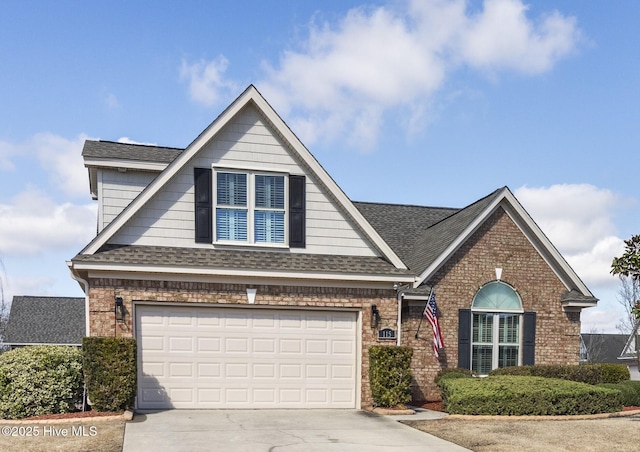 view of front facade featuring driveway, brick siding, and roof with shingles