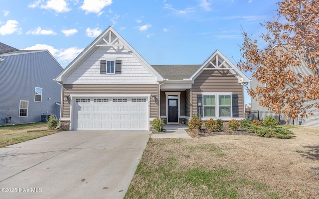 view of front of house with a garage, central air condition unit, and a front yard