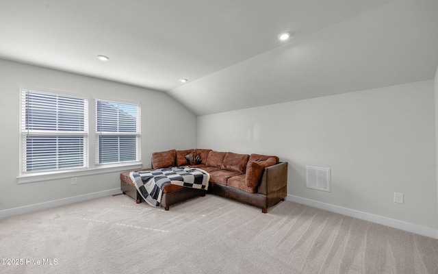 carpeted living room featuring vaulted ceiling