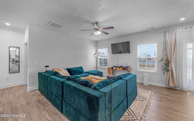 living room with light wood-type flooring and ceiling fan